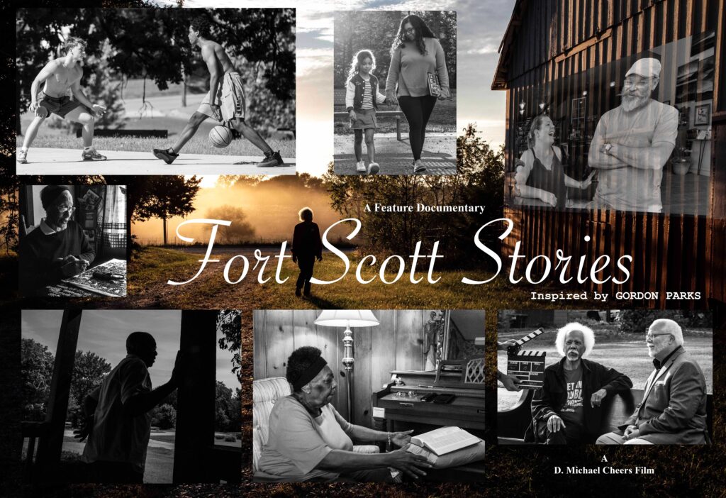 Movie poster for the feature documentary ‘Fort Scott Stories, Inspired by Gordon Parks.’ The design is a collage of black‑and‑white photographs featuring people in everyday scenes in and around Fort Scott, Kansas, with their faces obscured. At the top left, two teenagers play basketball outdoors; at the top center, a woman walks hand‑in‑hand with a young girl on a path; at the top right, a semi‑transparent image shows a conversation between two people inside a building, overlaid on the side of a wooden barn. Along the bottom row are images of an older woman working with her hands at a table, a person silhouetted while looking out from a porch, another woman sitting on a couch reading a book beside a lamp and piano, and two older adults seated on an outdoor bench while someone holds a clapperboard in front of them. In the center, a person walks alone down a grassy path toward bright morning light and trees. Elegant white script across the middle reads ‘Fort Scott Stories,’ with smaller text above and below stating ‘A Feature Documentary’ and ‘A D. Michael Cheers Film.’